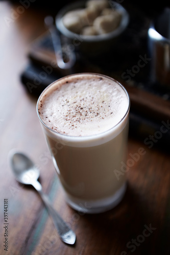 Coffee with milk on dark wooden background. Close up.