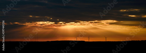 sunset view with windmills on the horizon