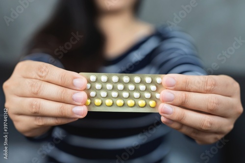 Concept birth control.Woman holding contraception pills.