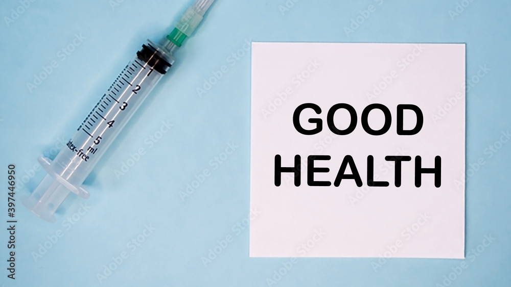 'Good health' message on sticker with syringe near. Medical concept. 'Good health' message on sticker with syringe near. Medical concept.