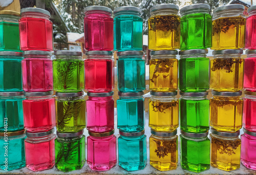 Glass jars of colored honey