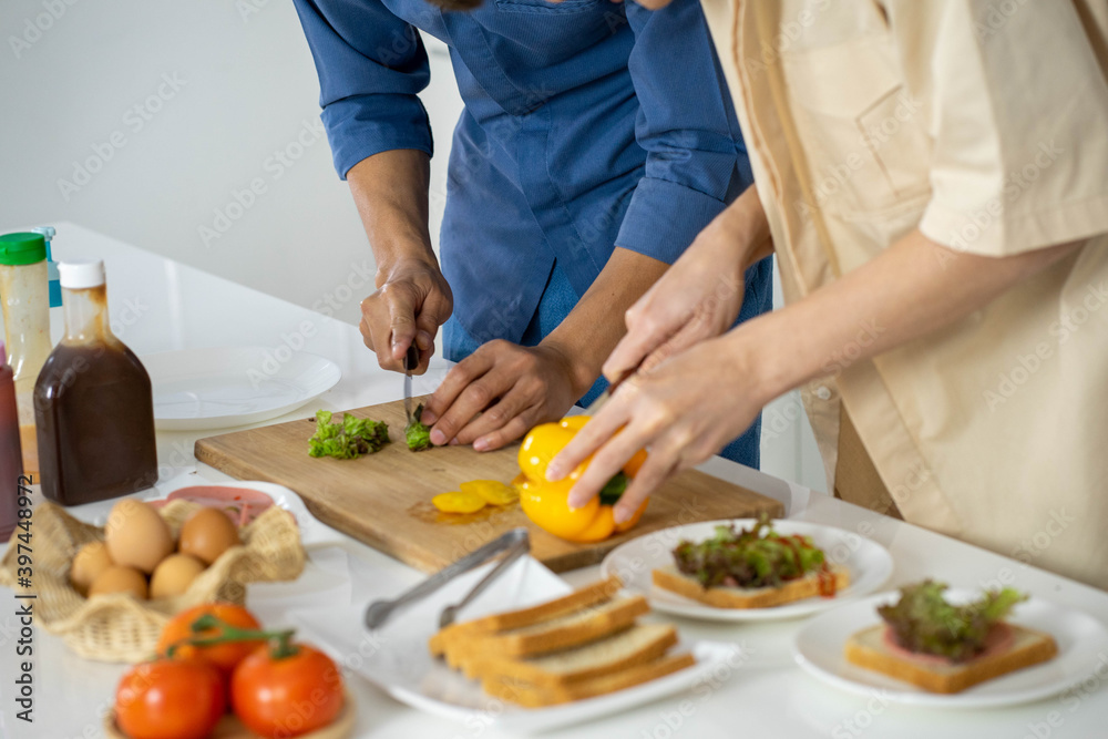 Asian man preparing homemade gourmet food cooking in the kitchen for holiday festival celebration. new normal concept.  work from home concept. 