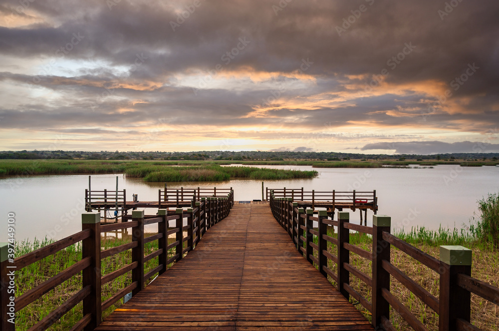 Sunset over a small pier in wetland area of the Isimangaliso National Park in KwaZulu-Natal region of South Africa.
