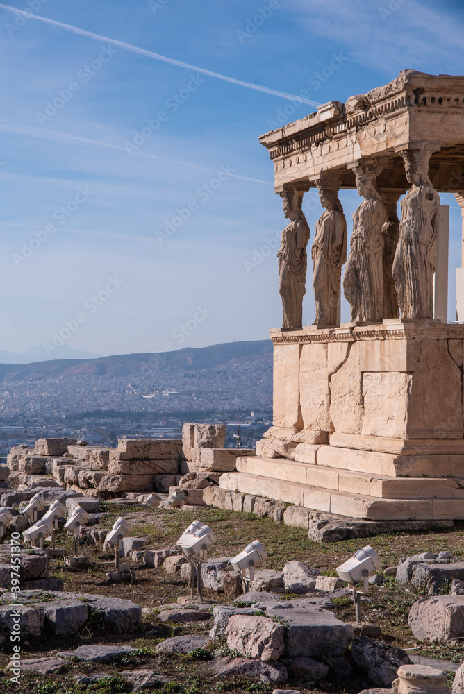 Obraz premium The Erechtheion or Erechtheum, an ancient Greek temple on north side of the Acropolis of Athens in Greece, dedicated to Athena and Poseidon, Greek Gods, overlooking Athens, Greece.