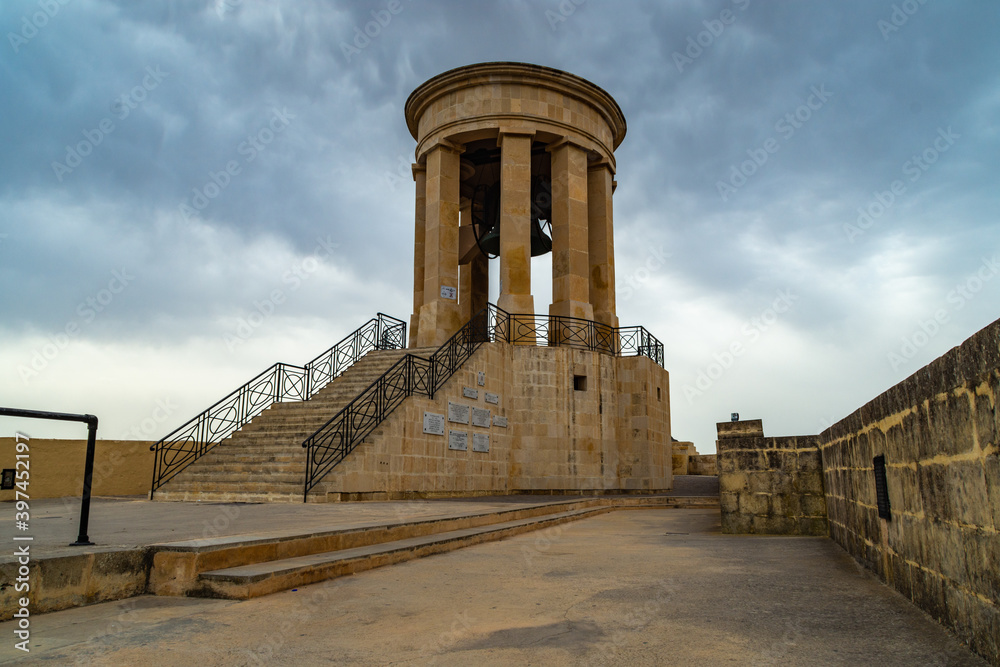 Dark clouds over the Siege Bell Memorial in Valletta, Malta.