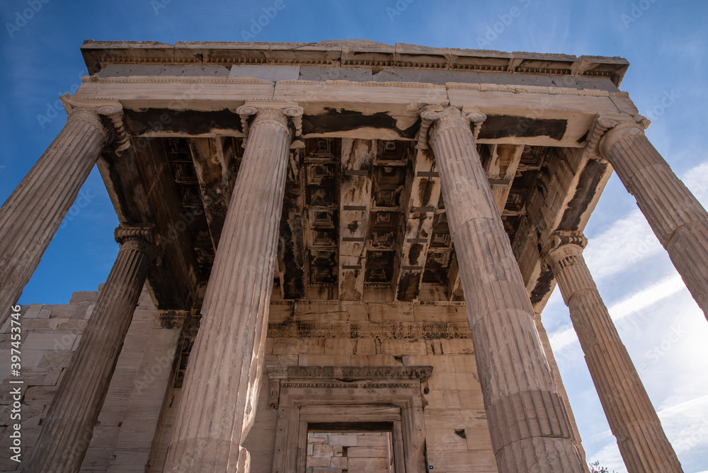 Obraz premium Ancient ruins of Propylaia or Propylaea, Acropolis, Athens, Greece. It is monumental gateway to the Acropolis, next to the Parthenon. Photo of iconic pillars and Greek arhitecture with beautiful sky.
