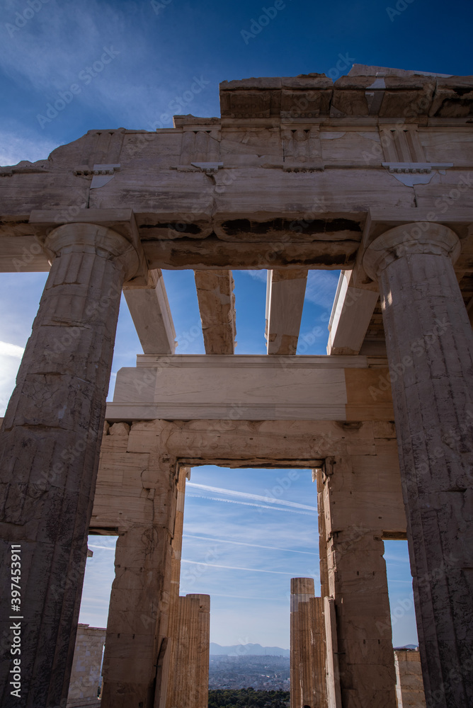 Ancient ruins of Propylaia or Propylaea, Acropolis, Athens, Greece. It is monumental gateway to the Acropolis, next to the Parthenon. Photo of iconic pillars and Greek arhitecture with beautiful sky.