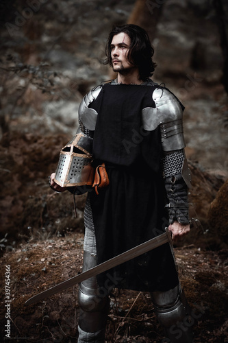 Knight in armor and with a sword. Medieval warrior