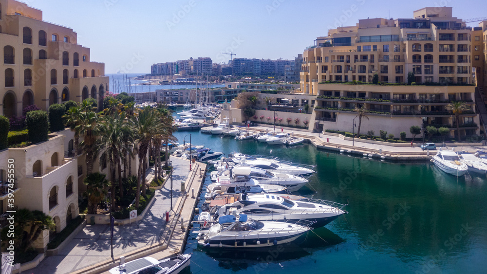 Yachts in Portomaso Marina surrounded by apartment blocks, in Saint Julian's, Malta.