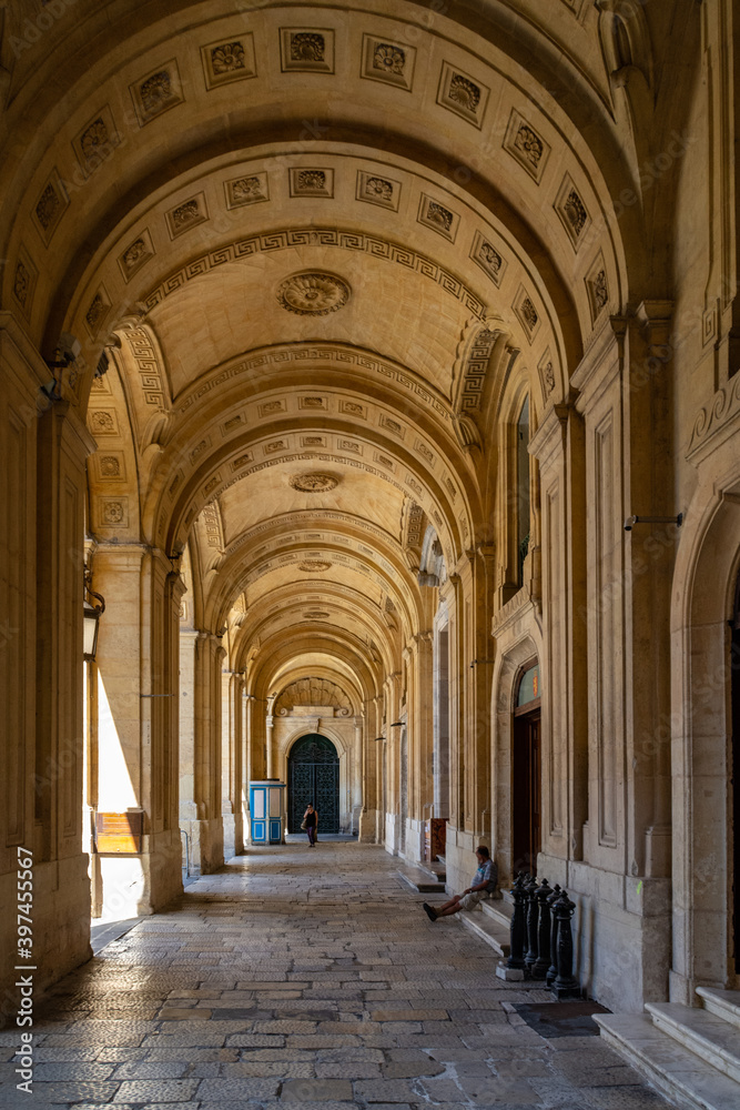 The passageway in front of the National Library of Malta in Valletta, Malta, which was founded in 1776 and known as Bibliotheca.
