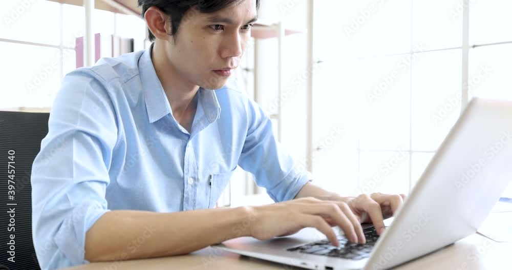 Businessman working on laptop computer sitting at workplace in modern office, work from home.