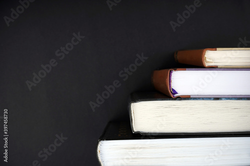 Staircase of books on black background. Knowledge, education concept. Copy space