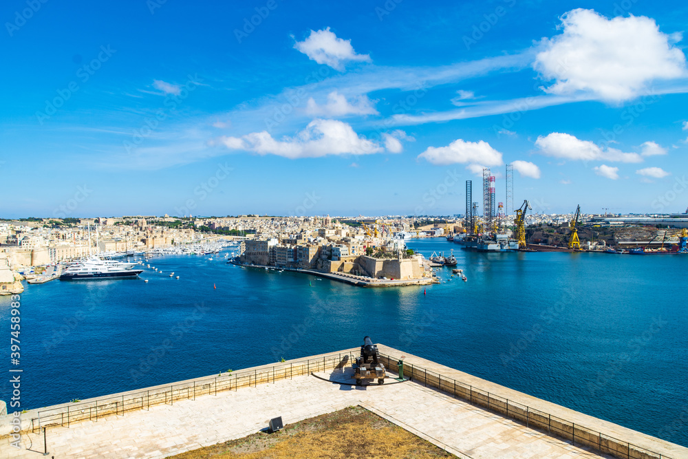 A single gun on the Saluting Battery in Valletta Malta over looking the Grand Harbour and the city of Birgu and  Senglea.