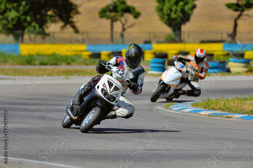 Motorcycle practice leaning into a fast corner on track