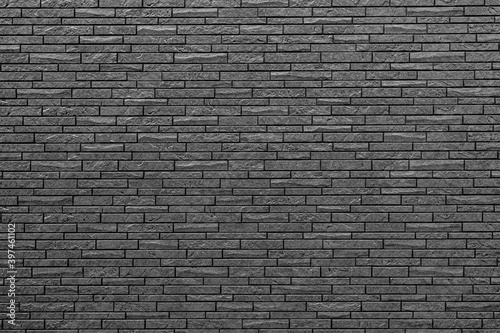 black wall made of decorative bricks, smooth texture