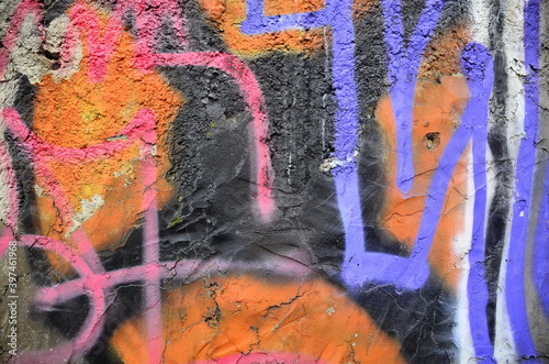 Abstraction in orange and black tones, painted on a concrete wall.