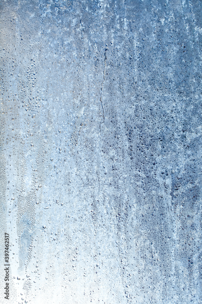 Frozen drops of condensation on a window, a sharp drop in temperature, sharply frozen drops of water on glass in winter, extremely cold low air temperatures Frozen drops of condensation on a window, a sharp drop in temperature, sharply frozen drops of water on glass in winter, extremely cold low air temperatures