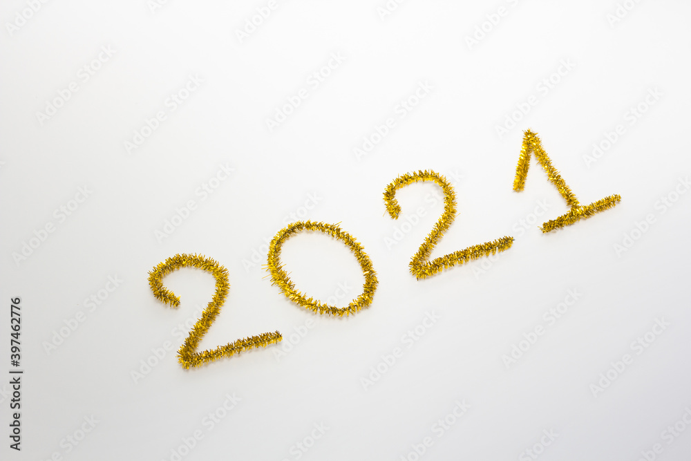 2021 number for New year greeting card. Christmas Party decoration on white background. Golden tinsel