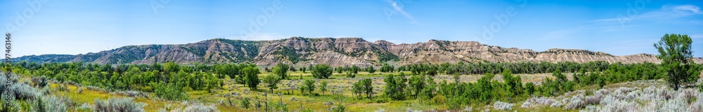 panoramic view of great plains with a backdrop of the badlands rising in the distance at Theodore Roosevelt National Park, North Dakota, USA