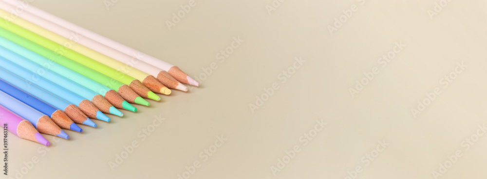 Fototapeta premium A set of pencils for drawing pastel colors on a light background.