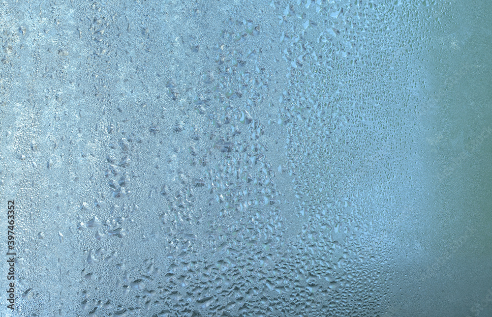 The texture of frozen drops of condensation on a transparent glass window. Water drops. Rain. Abstract texture background. A sharp cold snap, a frozen drop of water on the glass in winter The texture of frozen drops of condensation on a transparent glass window. Water drops. Rain. Abstract texture background. A sharp cold snap, a frozen drop of water on the glass in winter