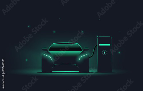 Electric car at charging station. Front view electric car silhouette with green glowing on dark background. EV concept. Vector illustration photo
