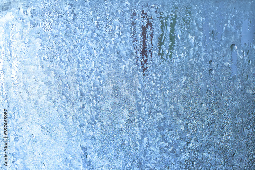 Frozen drops of condensation on a window, a sharp drop in temperature, sharply frozen drops of water on glass in winter, extremely cold low air temperatures