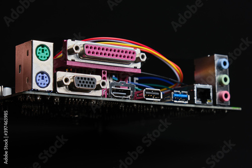 Motherboard back view panel with PS/2, HDMI, DVI, USB, lan and audio connectors on black background. 