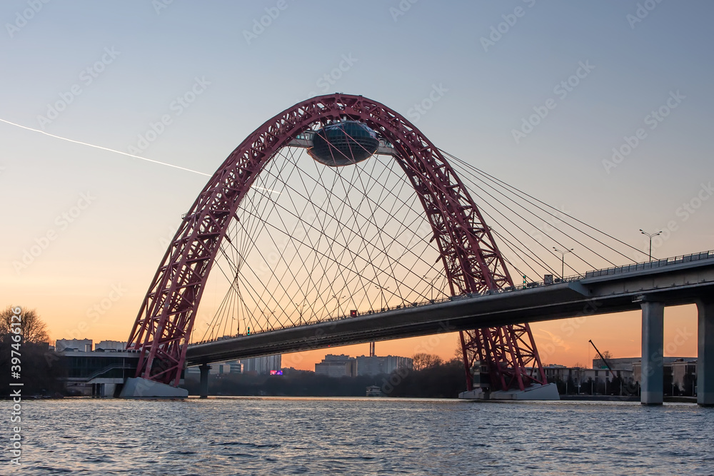 A beautiful picturesque bridge in Moscow. Unusual architecture. Bridge on the background of sunset. Bridge over the river. Quiet winter evening