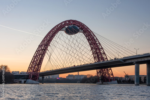 Fototapeta Naklejka Na Ścianę i Meble -  A beautiful picturesque bridge in Moscow. Unusual architecture. Bridge on the background of sunset. Bridge over the river. Quiet winter evening