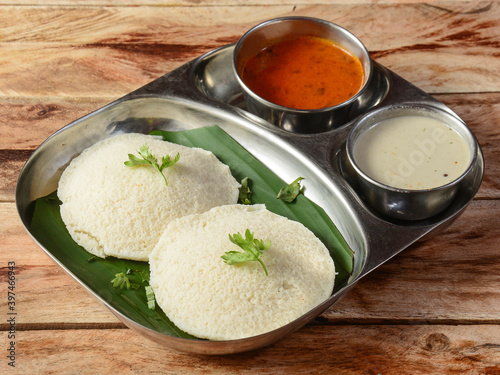 Idli or idly is a healthy Indian, vegetarian, traditional and popular steam cooked rice cakes served with bowls of chutney and sambar as side dishes.selective focus photo