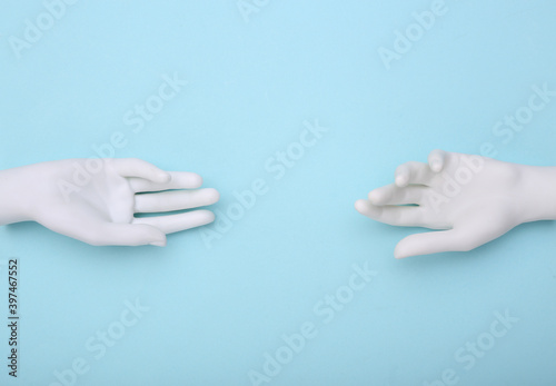 White mannequin hands on blue background. Minimalism. Concept art