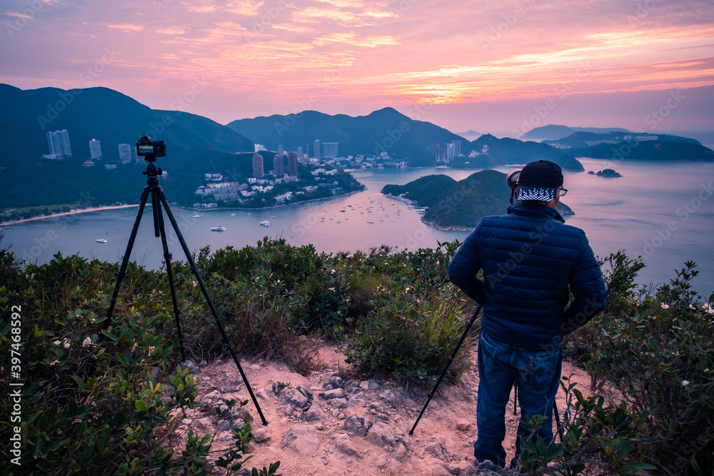 Overlooking view of Middle islands, buildings in seaside at Deep Water Bay, Hong Kong seen form brick hill (nam long shan) in sunrise time