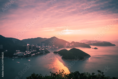 Overlooking view of Middle islands, buildings in seaside at Deep Water Bay, Hong Kong seen form brick hill (nam long shan) in sunrise time photo