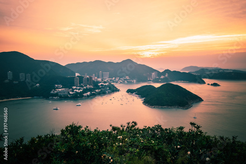 Overlooking view of Middle islands, buildings in seaside at Deep Water Bay, Hong Kong seen form brick hill (nam long shan) in sunrise time © kingrobert