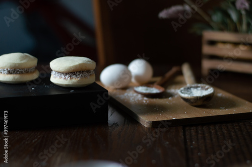 Uruguayan and Argentinian alfajor in dark scenery. Typical South American food. Chocolate cake with dulce de leche filling. Uruguay. Argentina
