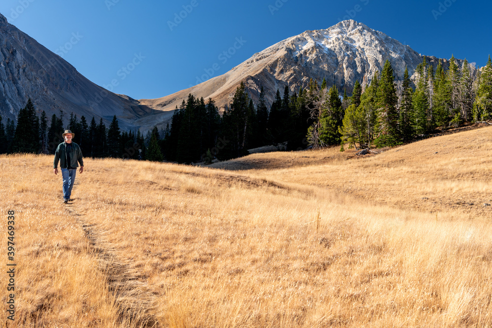 Man follows a hiking trail through the mountains