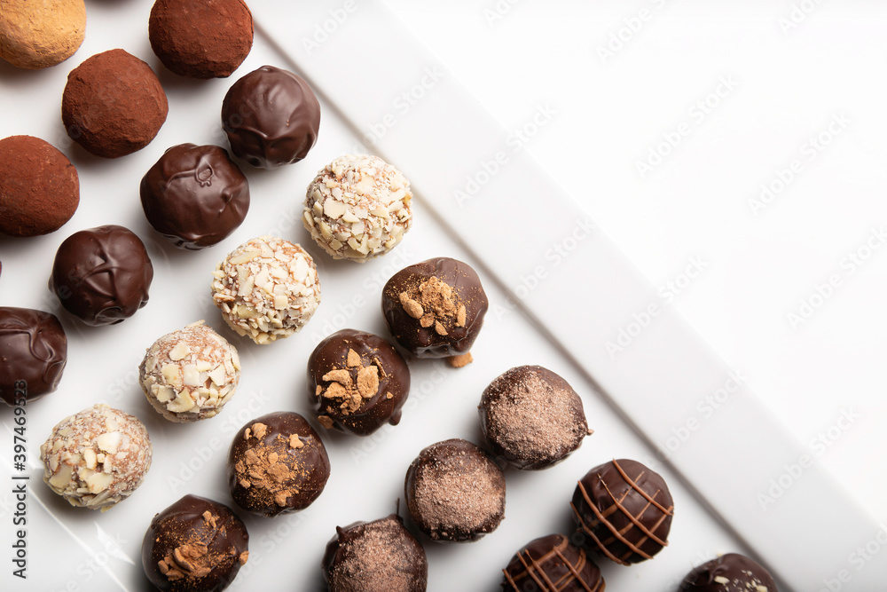 variety of handmade gourmet chocolate truffle candy on a white plate variety of handmade gourmet chocolate truffle candy on a white plate
