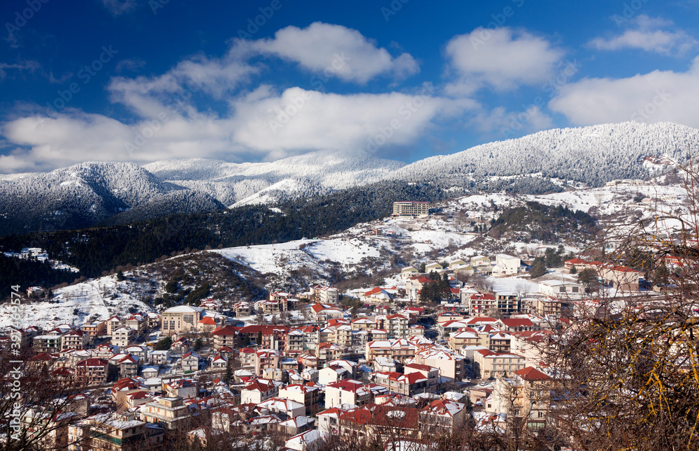 Panoramic view of the city of Karpenisi, in Evritania region, central Greece. It is a snowy day in mid January, in the middle of winter.