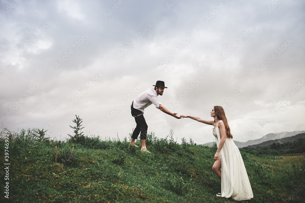 Beautiful young couple. Wedding photo session outdoors in the mountains. Happy couple. New family. Beautiful young couple. Wedding photo session outdoors in the mountains. Happy couple. New family.