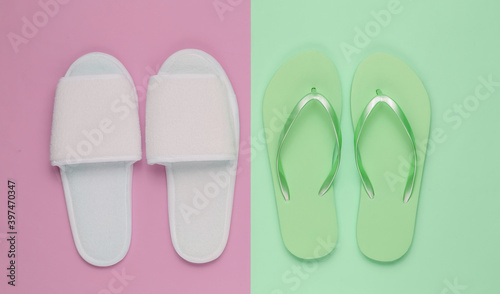 Slippers and flip-flops on colored paper background. Minimalistic fashion concept. Top view