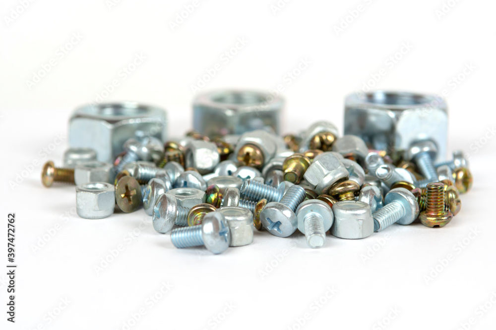 assorted bolts and nuts on a white background assorted bolts and nuts on a white background