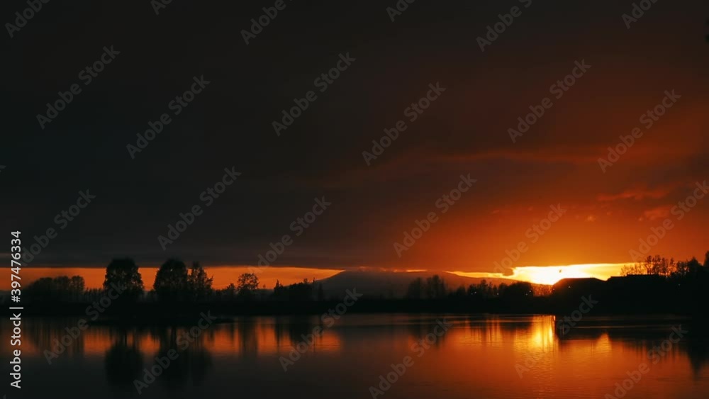 spectacular and very colorful sunset over the a lake . Beautiful panoramic sunset reflecting on small pond in North Pole, Alaska. Alaska spectacular and very colorful sunset over the a lake . Beautiful panoramic sunset reflecting on small pond in North Pole, Alaska. Alaska