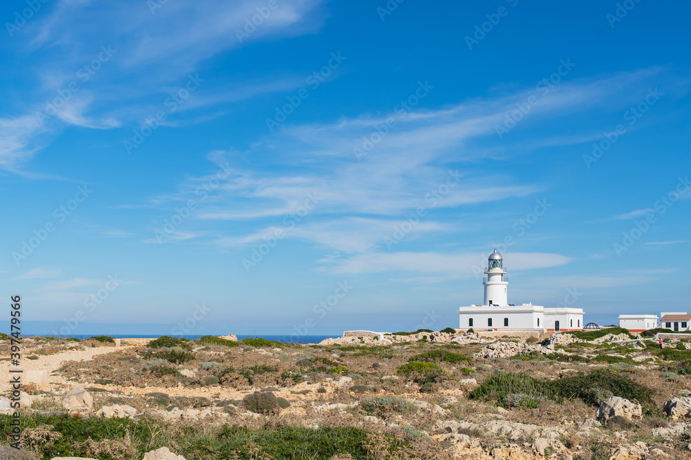Building of Faro de Cavalleria in Minorca, with a blue sky in horizontal, with no people Building of Faro de Cavalleria in Minorca, with a blue sky in horizontal, with no people