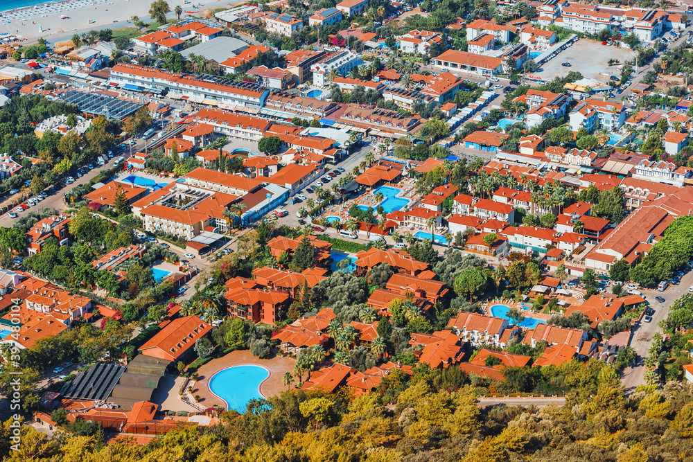 Resort town or village with numerous hotels and cottages with turquoise water in swimming pools. Aerial view. Tourism and recreation in hot countries