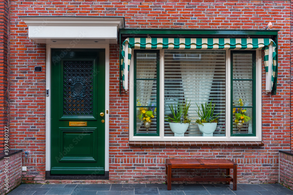 Typical Dutch village houses facade. Beautiful and authentic style at Volendam. Netherlands. Typical Dutch village houses facade. Beautiful and authentic style at Volendam. Netherlands.