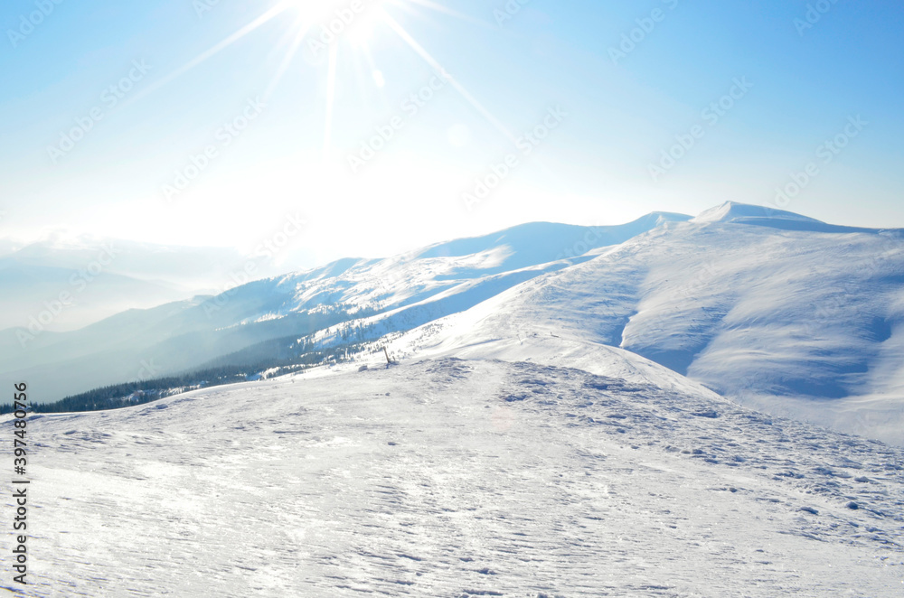 Winter mountain landscape with sun. Great place for winter sports. Beautiful winter landscape