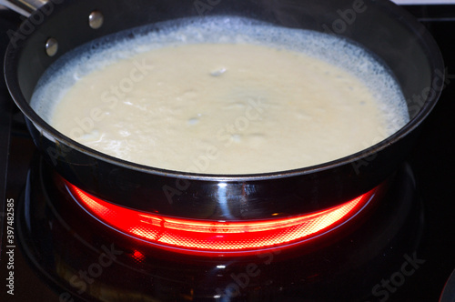 Heating batter in a skillet to make crepes
