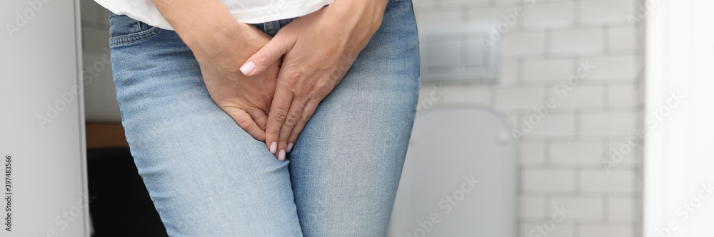 Female hands between legs in jeans close-up. Diagnosis and treatment of sexually transmitted diseases concept. Female hands between legs in jeans close-up. Diagnosis and treatment of sexually transmitted diseases concept.