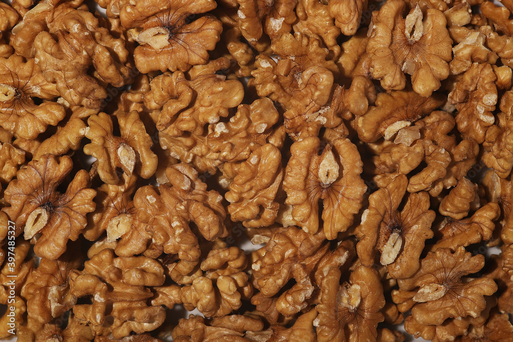 Heap of raw walnuts close-up as background. Heap of raw walnuts close-up as background.